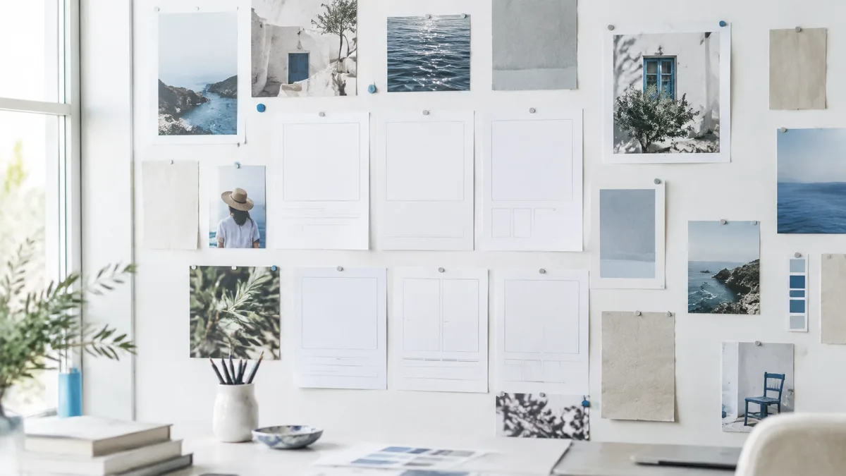Printed cards and brand materials arranged on a bright studio wall
